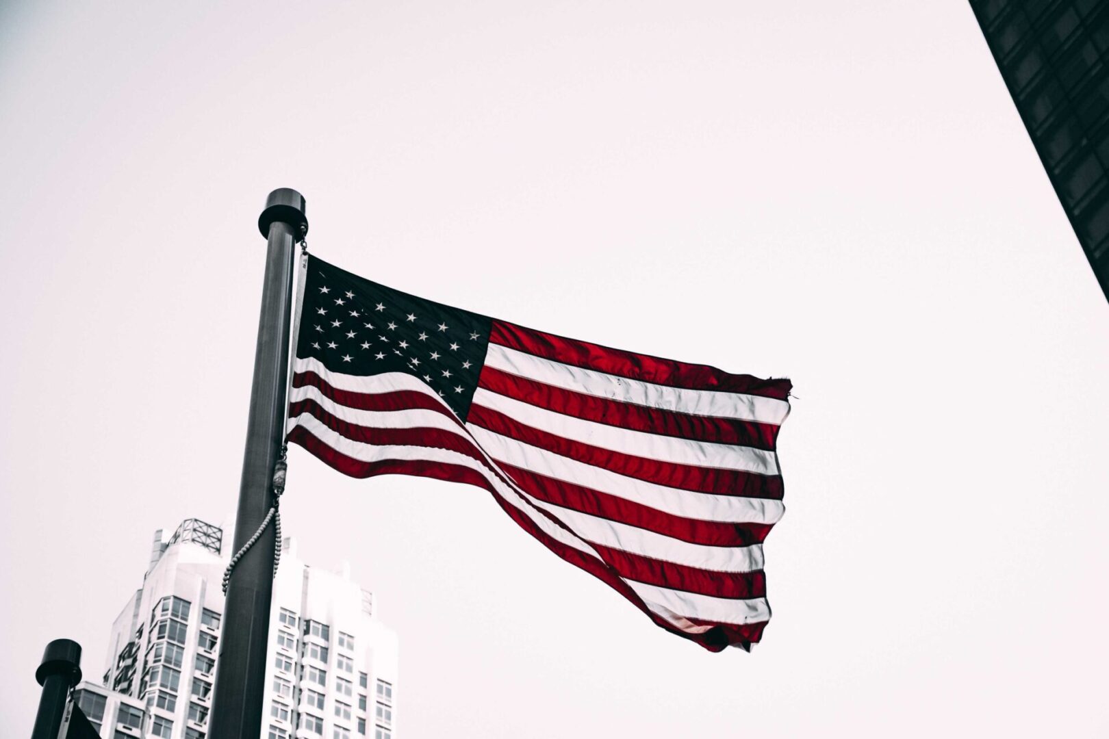 A flag flying on top of a pole in the sky.