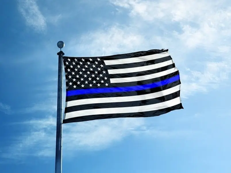 A flag with the american flag and blue line on it.